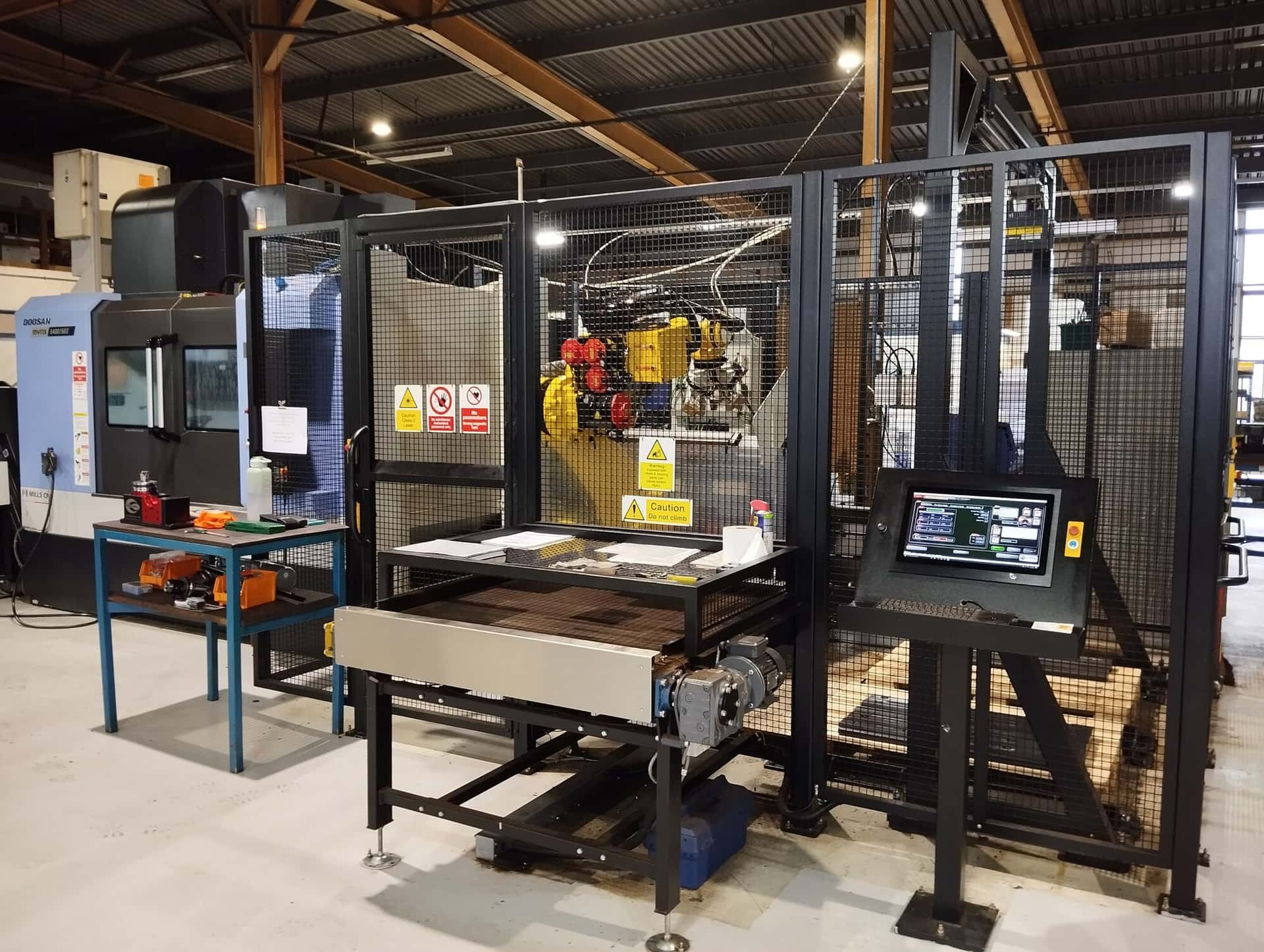 Robot loaded milling cell machining rail fishplates